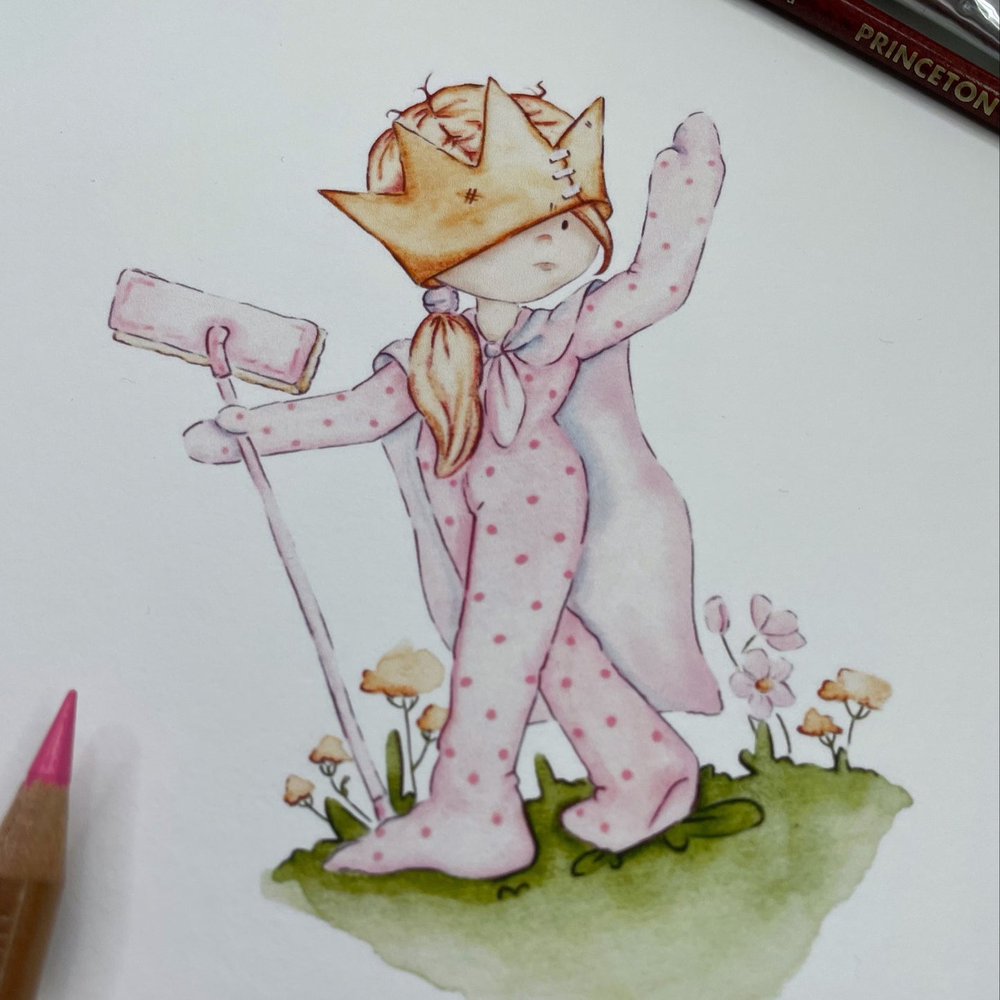 Illustration of a character in pink pajamas with a crown, holding a rolled-up paper, on a white background.
